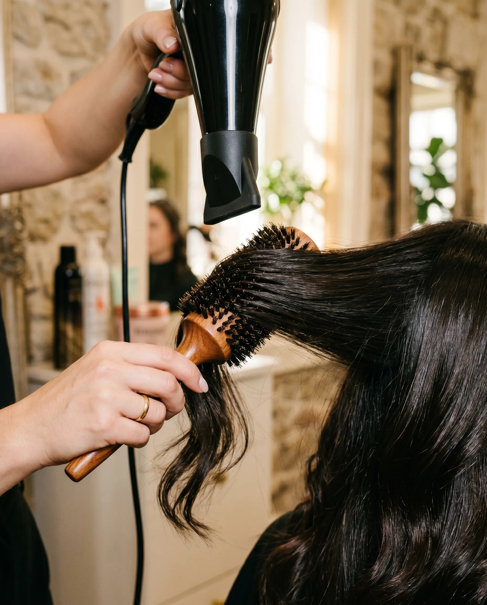 Round brush smoothing glossy hair beneath a professional blow dryer at a Palo Alto salon